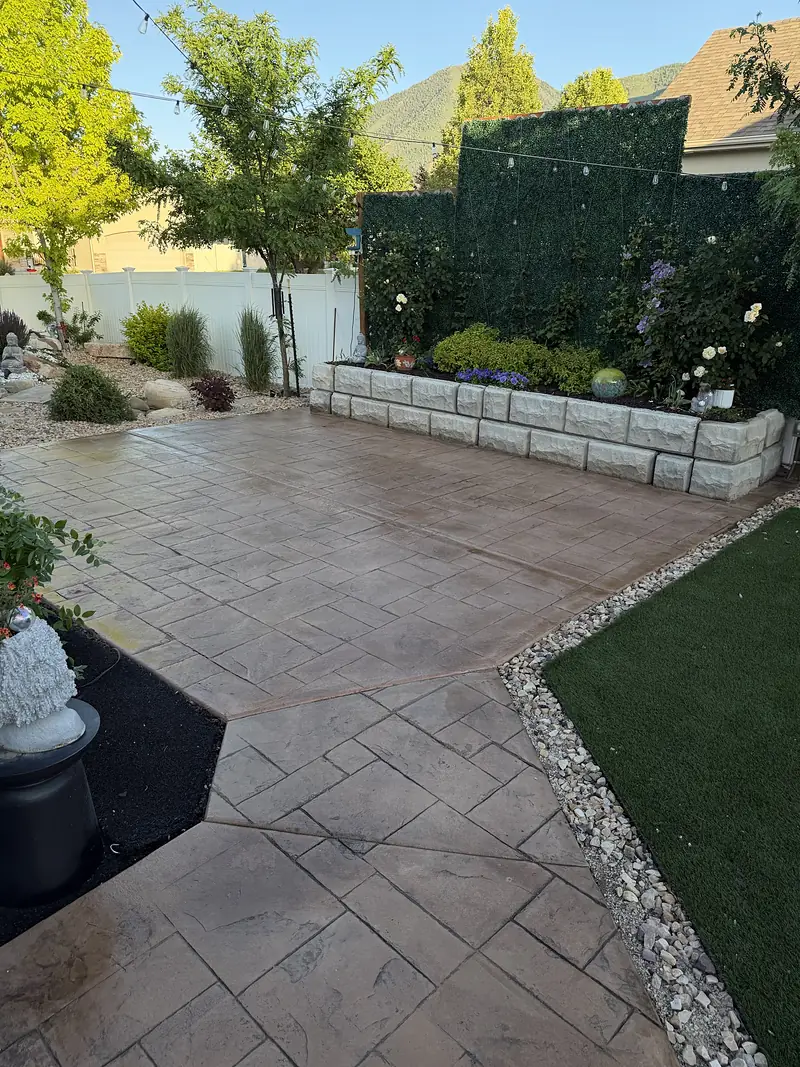 Stamped concrete patio with flower bed and mountain view, freshly sealed