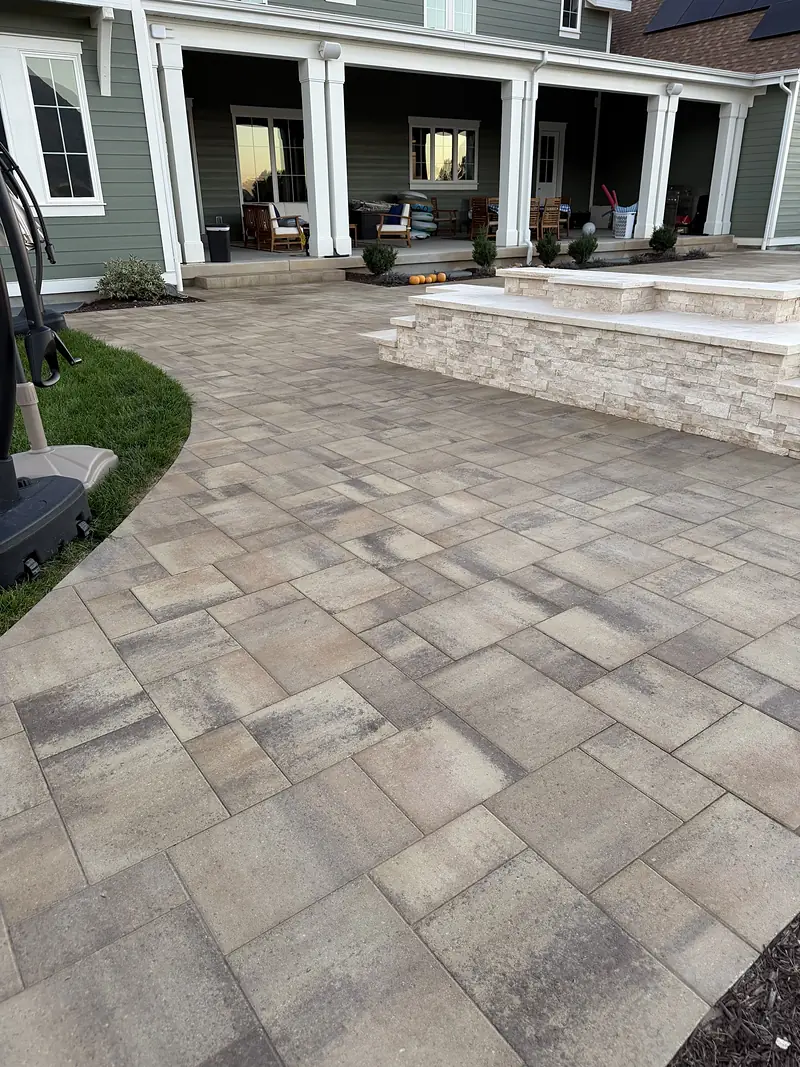 Paver patio wrapping a covered back porch